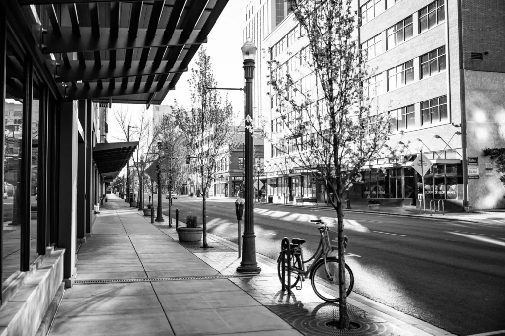 A quiet city street framed by modern buildings